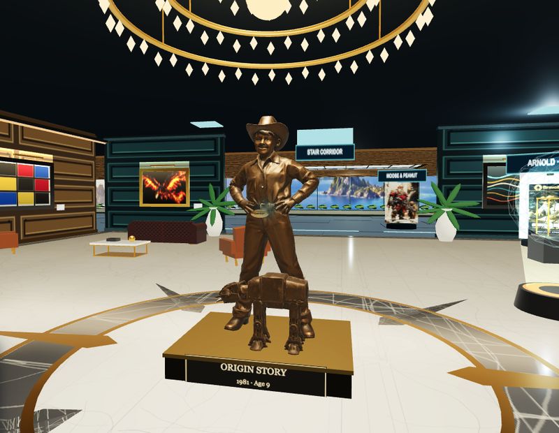 BravoBay HQ Tour In-game still: the Visitor Lounge, with the bronze Origin Story statue under the chandelier